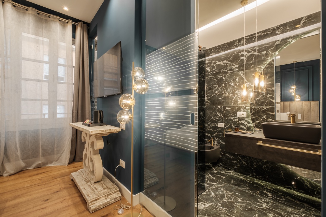 Bedroom with window and marble bathroom view