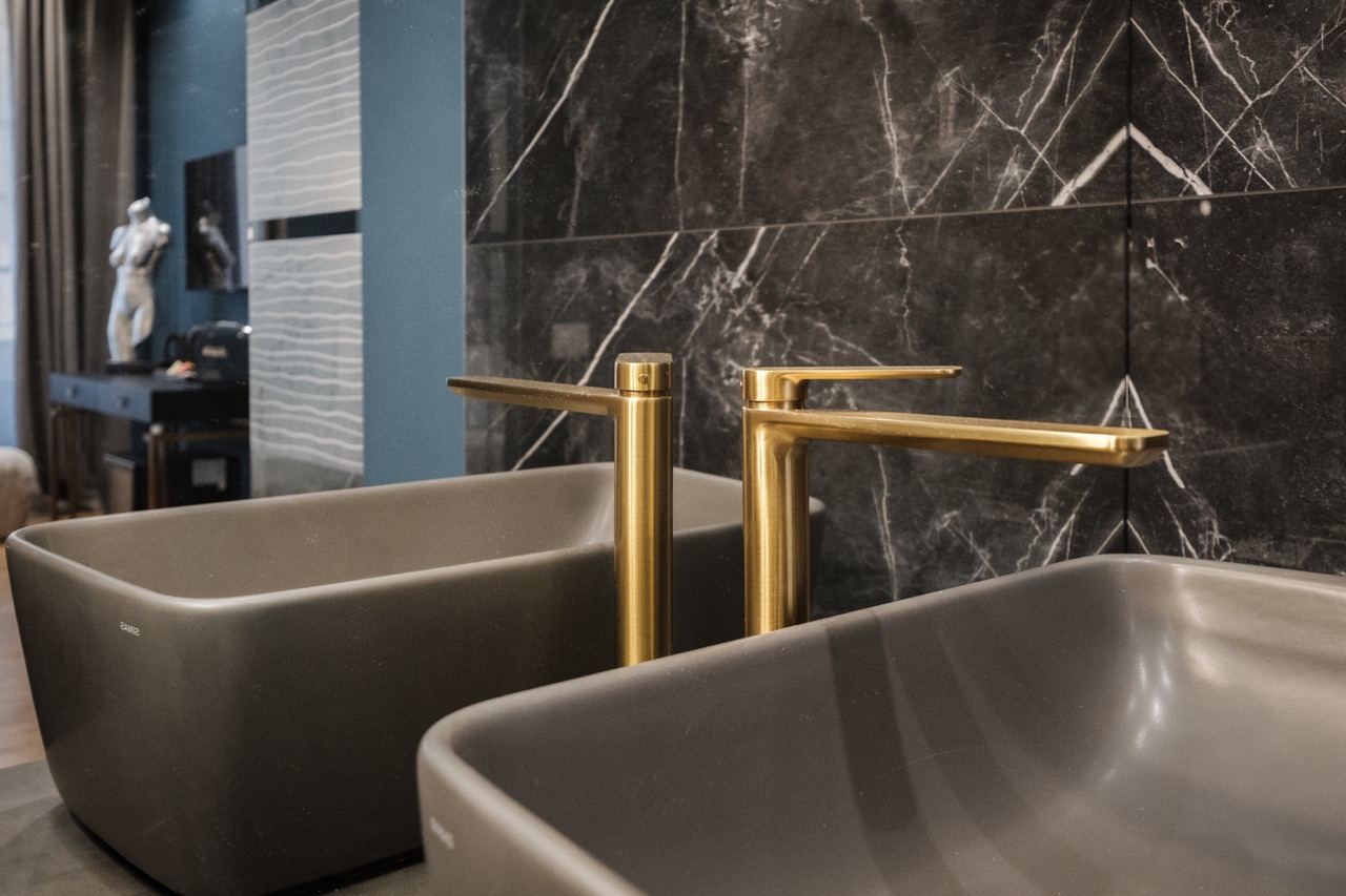 Double vessel sinks with gold faucets